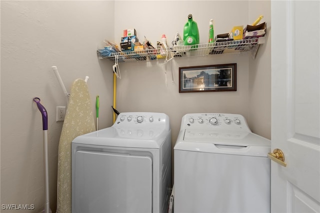 clothes washing area with washer and clothes dryer