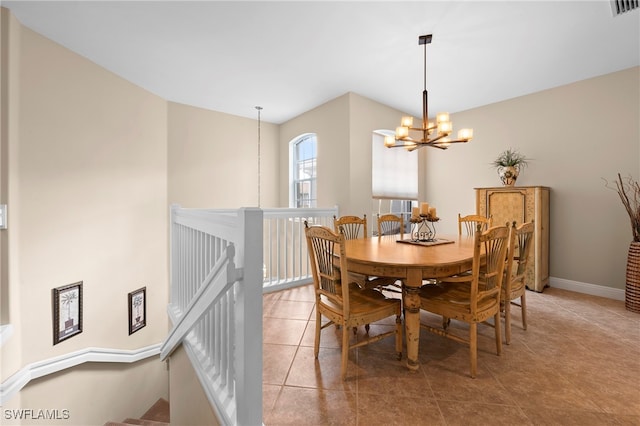 tiled dining space with an inviting chandelier