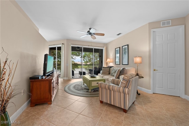 tiled living room with ceiling fan