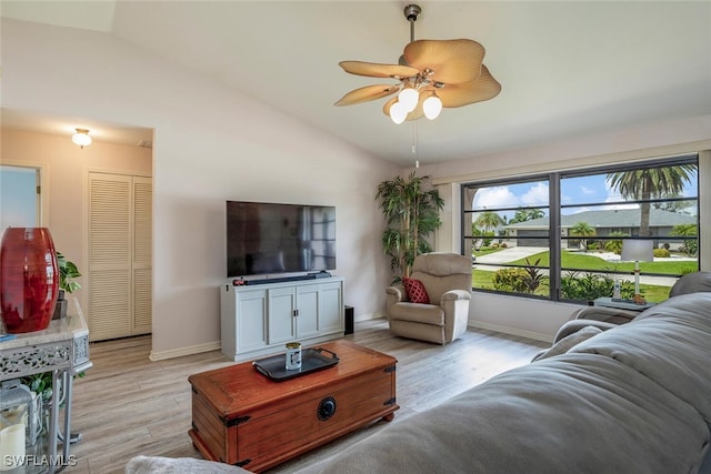 living room featuring lofted ceiling, light hardwood / wood-style flooring, and ceiling fan