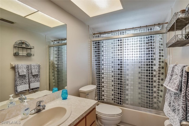 full bathroom with enclosed tub / shower combo, toilet, and vanity