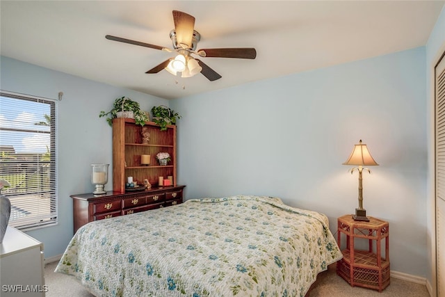 carpeted bedroom with a closet and ceiling fan