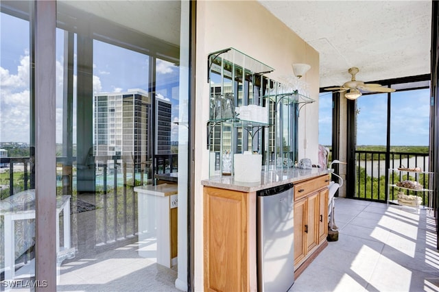 kitchen featuring stainless steel fridge, floor to ceiling windows, ceiling fan, and plenty of natural light