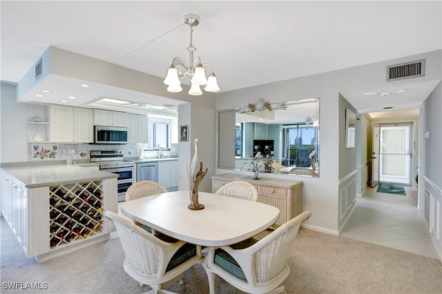 dining space with light carpet, a notable chandelier, and plenty of natural light