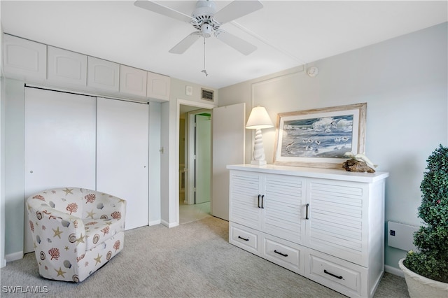 living area featuring ceiling fan and light colored carpet