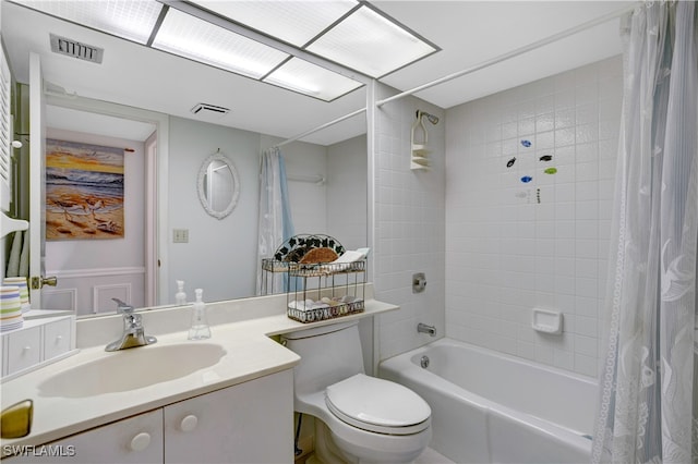 full bathroom with shower / tub combo with curtain, vanity, and toilet