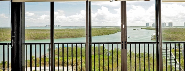 unfurnished sunroom featuring a water view and a wealth of natural light