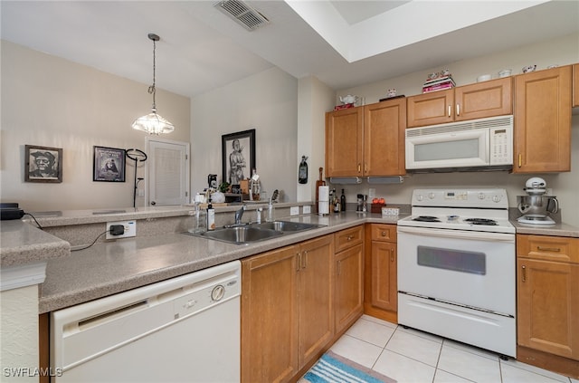 kitchen with decorative light fixtures, white appliances, light tile patterned floors, kitchen peninsula, and sink