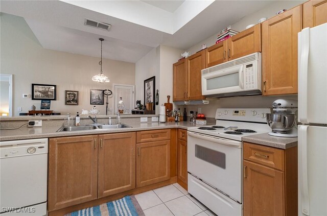 kitchen with hanging light fixtures, light tile patterned floors, white appliances, sink, and kitchen peninsula