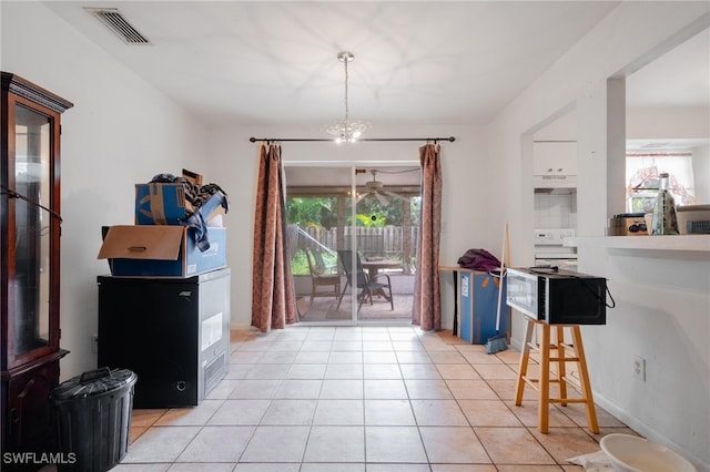 dining area with a chandelier, light tile patterned floors, and plenty of natural light