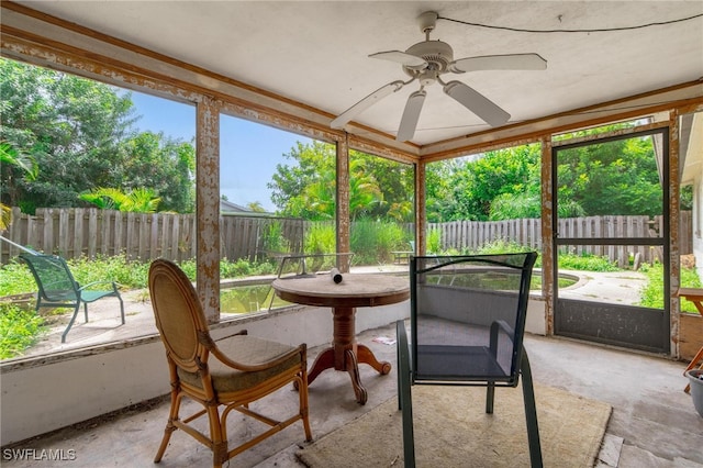 sunroom with a healthy amount of sunlight and ceiling fan