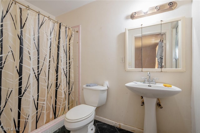 bathroom featuring tile patterned flooring, toilet, and curtained shower