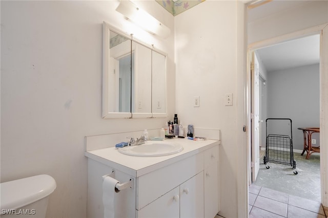 bathroom with vanity, toilet, and tile patterned floors