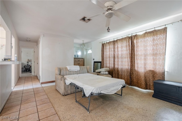 tiled living room with ceiling fan