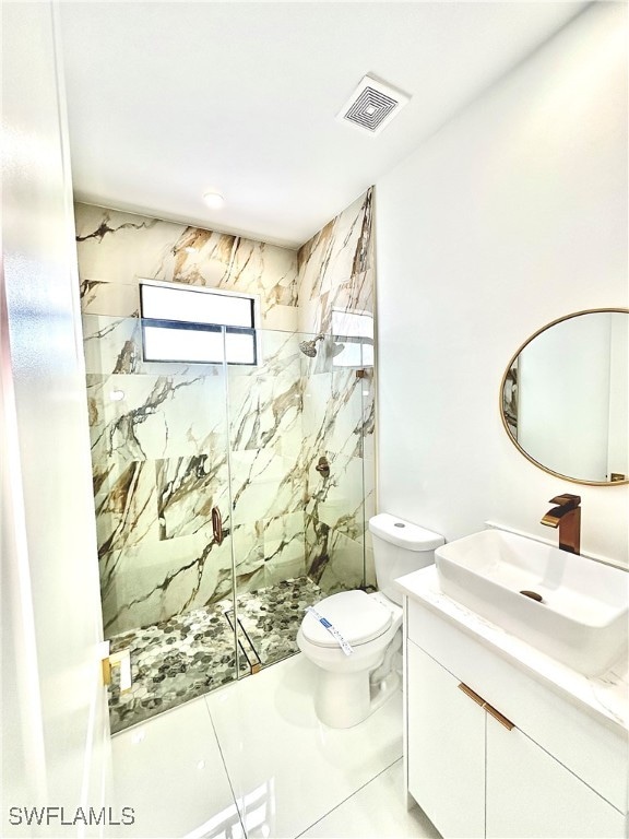 bathroom with tile patterned floors, toilet, a shower with door, and vanity