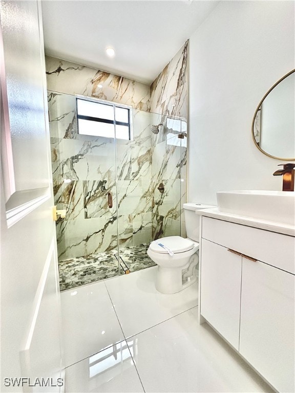 bathroom with vanity, toilet, tile patterned flooring, and a shower with door