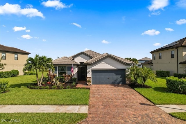 view of front of property featuring a front yard and a garage