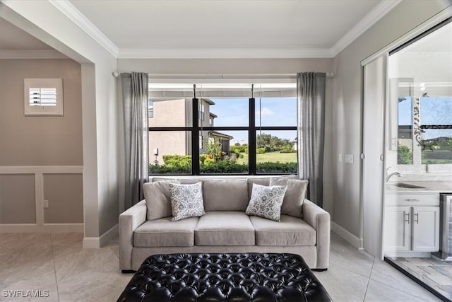 tiled living room with crown molding, sink, and a wealth of natural light