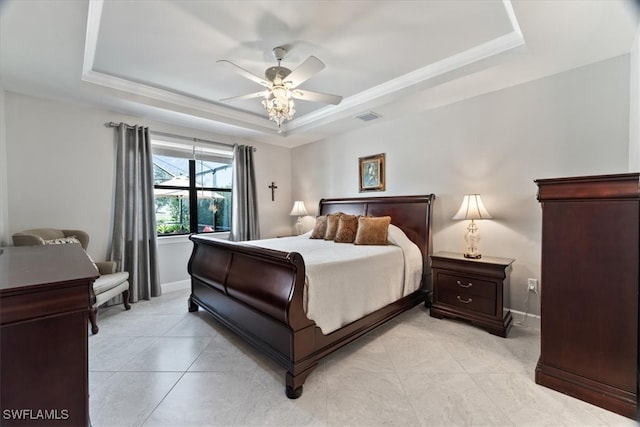 bedroom with a raised ceiling, crown molding, and ceiling fan