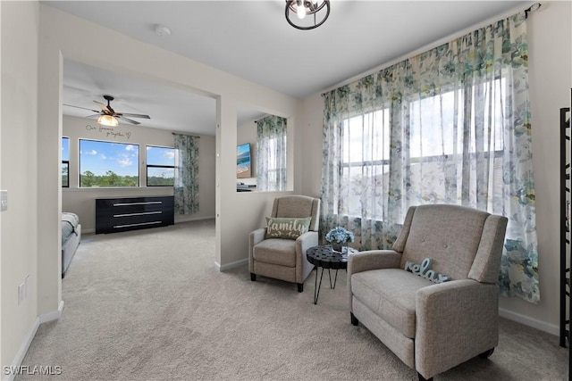 sitting room with ceiling fan and carpet floors