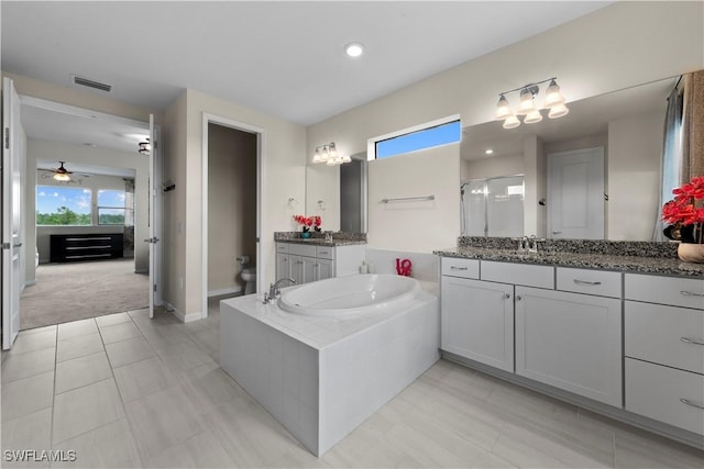 full bathroom featuring ceiling fan, plus walk in shower, tile patterned flooring, toilet, and vanity