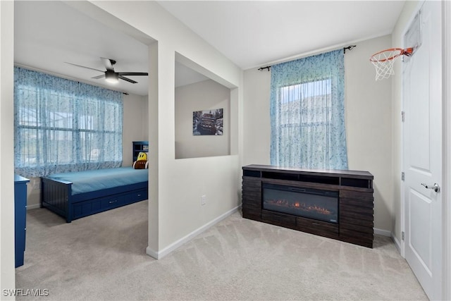 bedroom featuring light colored carpet and ceiling fan