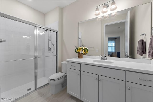 bathroom featuring walk in shower, vanity, and toilet