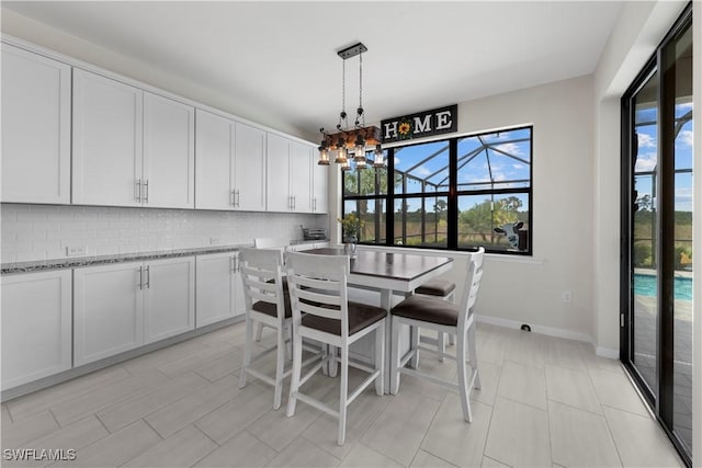 dining area featuring an inviting chandelier