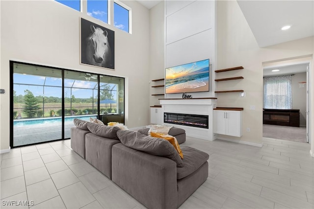 living room featuring a healthy amount of sunlight and a towering ceiling