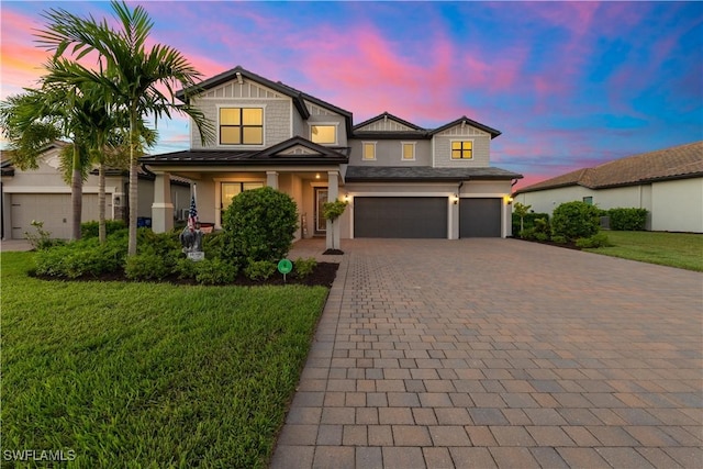 view of front of home featuring a garage and a yard