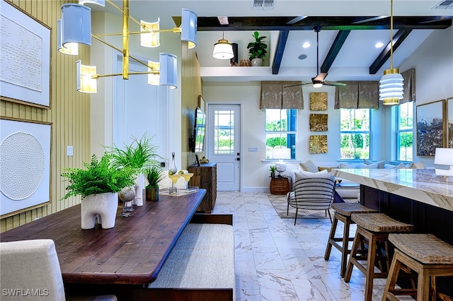 dining area featuring beam ceiling, a high ceiling, and ceiling fan