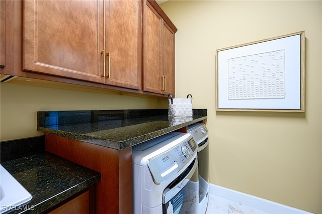 laundry area with cabinets and washer and clothes dryer