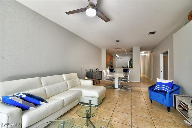 tiled living room featuring ceiling fan