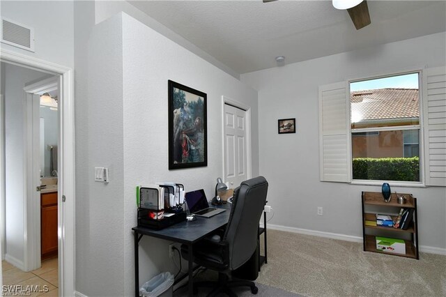 office with light carpet and ceiling fan