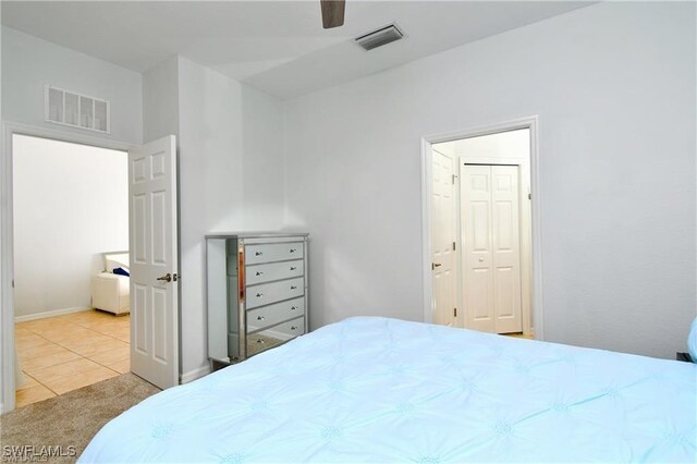 tiled bedroom with a closet and ceiling fan