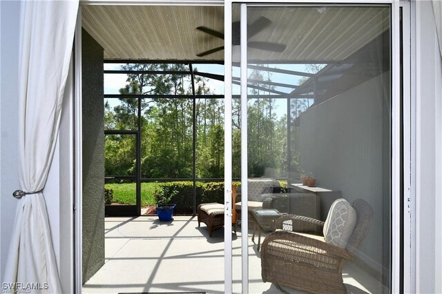 doorway to outside featuring ceiling fan