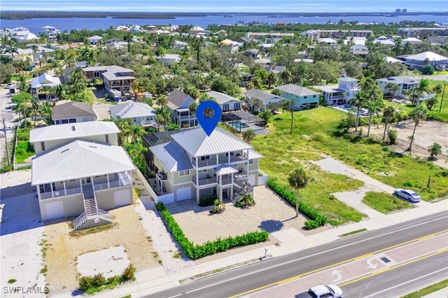 birds eye view of property featuring a water view and a residential view