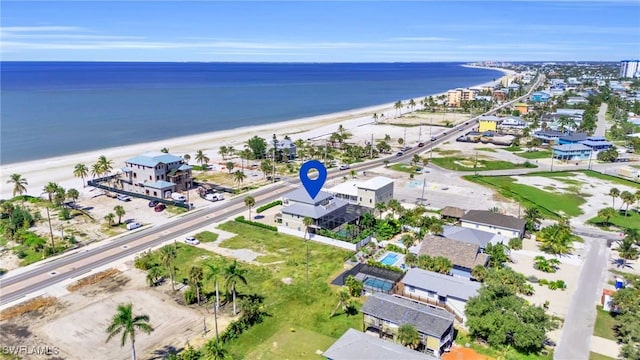 aerial view with a water view and a beach view