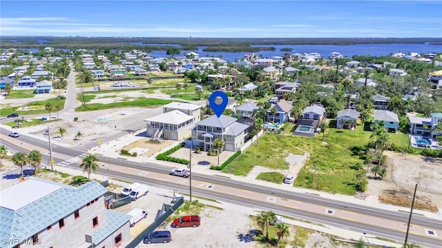 drone / aerial view with a residential view and a water view