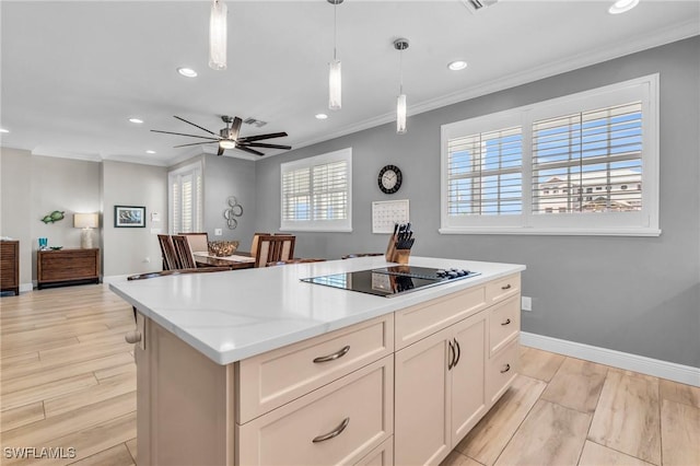 kitchen featuring ornamental molding, a center island, pendant lighting, and black electric cooktop