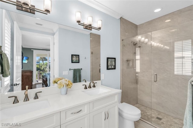 full bath featuring double vanity, a stall shower, a sink, and crown molding