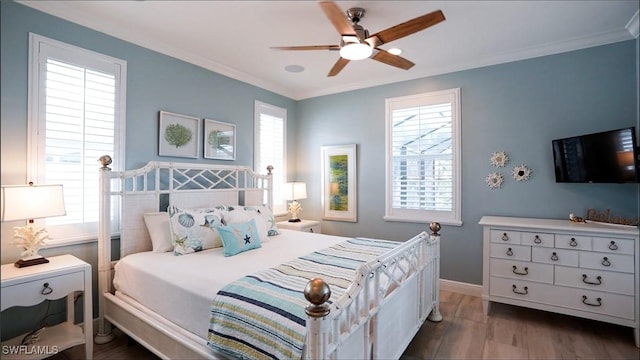 bedroom with baseboards, dark wood-style flooring, and crown molding