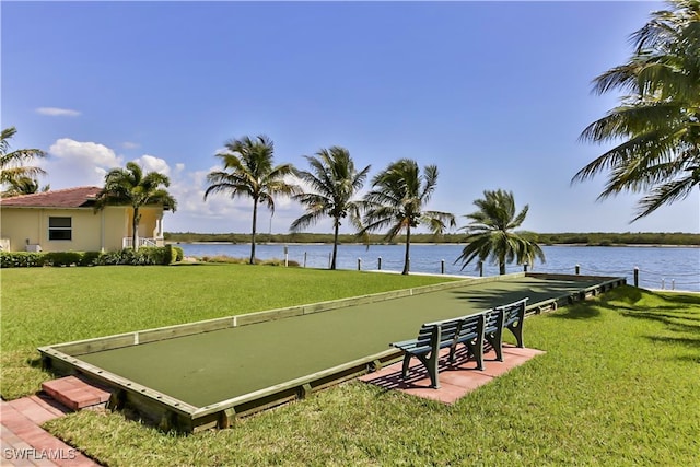 surrounding community featuring a lawn and a water view