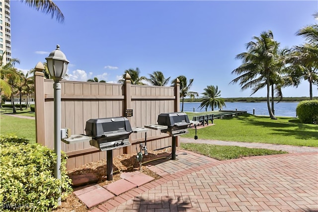 view of patio / terrace with area for grilling and a water view