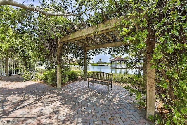 view of patio / terrace with a water view and a pergola