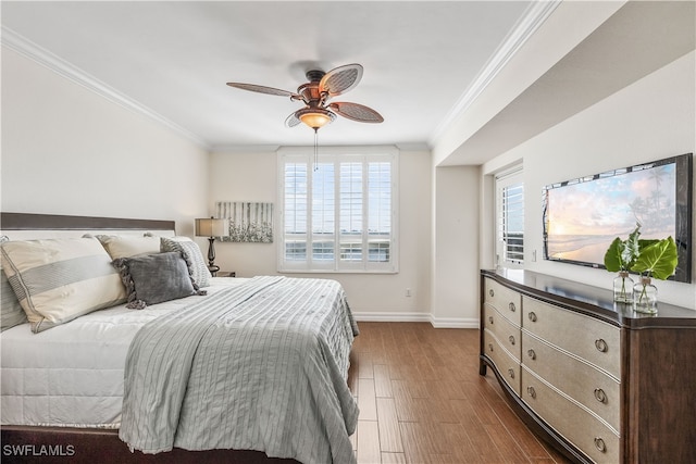 bedroom with crown molding, ceiling fan, and dark hardwood / wood-style flooring