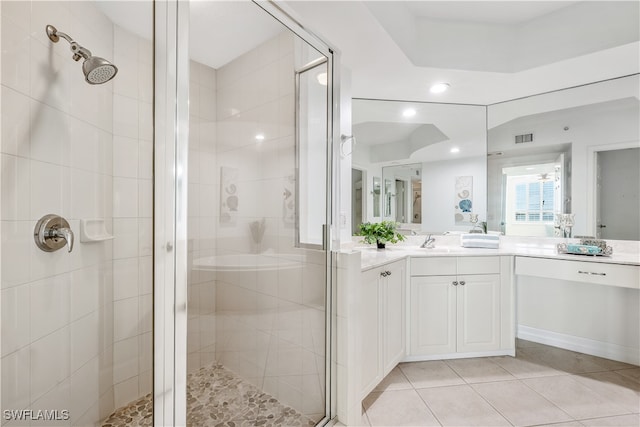 bathroom featuring a shower with door, vanity, and tile patterned floors