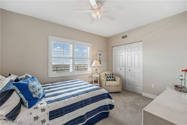 bedroom featuring a closet, ceiling fan, and light colored carpet