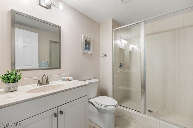 bathroom with vanity, tile patterned floors, toilet, and an enclosed shower