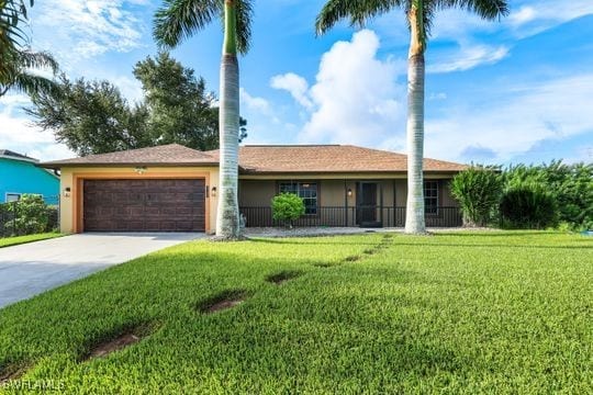 ranch-style house featuring a garage and a front lawn